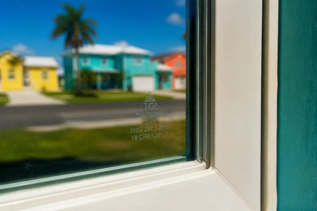 A small etched label in the lower corner of a glass pane