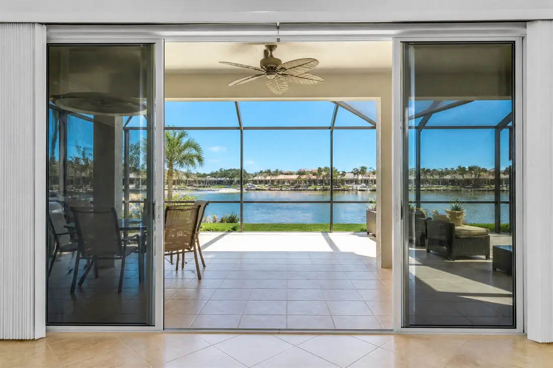 A wide sliding glass door onto a screened lanai on a Cape Coral house
