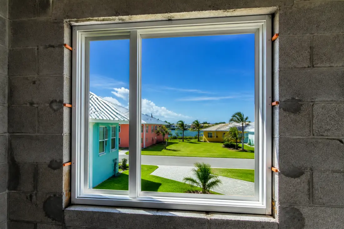 A window frame set in a masonry opening with shims and anchors through the frame flange